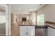 Open kitchen with stainless appliances, white cabinets, and views of the living room and fireplace at 7637 W North Ln, Peoria, AZ 85345