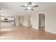 Spacious open-concept living room with a tile floor, leading into a kitchen area at 7637 W North Ln, Peoria, AZ 85345