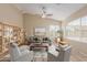 Bright living room with vaulted ceilings, ceiling fan, and neutral decor, creating a cozy atmosphere at 7637 W North Ln, Peoria, AZ 85345