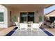 Outdoor patio space has white wooden table and grill at 7637 W North Ln, Peoria, AZ 85345