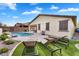 Landscaped backyard boasts a sparkling pool, patio space, and lush artificial turf at 7769 S Reseda St, Gilbert, AZ 85298
