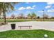 Community park with basketball court, grassy areas, and walking paths under a sunny sky at 7769 S Reseda St, Gilbert, AZ 85298