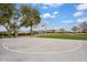 Community park with basketball court, grassy areas, and walking paths under a sunny sky at 7769 S Reseda St, Gilbert, AZ 85298