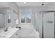 Well-lit bathroom with a separate tub and shower, and a large window for natural light at 7769 S Reseda St, Gilbert, AZ 85298