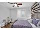 Stylish bedroom with a feature wall, desk area, and shuttered window for natural light at 7769 S Reseda St, Gilbert, AZ 85298