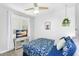 Comfortable bedroom featuring blue bedding, a TV, and soft natural light at 7769 S Reseda St, Gilbert, AZ 85298
