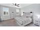 Serene bedroom with a wood accent wall, soft carpet, and matching nightstands and dresser at 7769 S Reseda St, Gilbert, AZ 85298