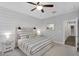 Comfortable bedroom with a wood accent wall, soft lighting, and a calming, neutral color scheme at 7769 S Reseda St, Gilbert, AZ 85298