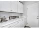 Convenient butler's pantry featuring white cabinetry, quartz countertops, and stylish decor at 7769 S Reseda St, Gilbert, AZ 85298