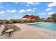 Relaxing community pool with covered seating, lounge chairs, and scenic landscaping at 7769 S Reseda St, Gilbert, AZ 85298