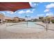 Resort-style community pool featuring a splash pad, lounge chairs, umbrellas, and clubhouse at 7769 S Reseda St, Gilbert, AZ 85298