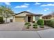 Inviting home with well-maintained landscaping and a spacious brick driveway leading to a two-car garage at 7769 S Reseda St, Gilbert, AZ 85298