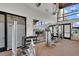 Spacious gym featuring weight machines, mirrors, and large windows for a bright workout environment at 7769 S Reseda St, Gilbert, AZ 85298