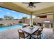 Covered patio with ceiling fan, outdoor dining, and a full outdoor kitchen at 7769 S Reseda St, Gilbert, AZ 85298