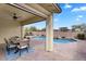 Covered patio with ceiling fan, outdoor dining, and a pool view at 7769 S Reseda St, Gilbert, AZ 85298