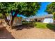 The backyard features a lush green lawn and covered patio area with a charming shed at 8345 E Oak St, Scottsdale, AZ 85257