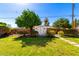 Lush backyard with trees and grass, featuring a white storage shed at 8345 E Oak St, Scottsdale, AZ 85257