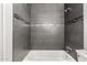 This updated bathroom shows dark tile with a bathtub and shower at 8345 E Oak St, Scottsdale, AZ 85257