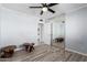 A comfortable bedroom features modern floors, sliding mirror door and ceiling fan at 8345 E Oak St, Scottsdale, AZ 85257
