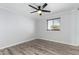 This airy bedroom features a ceiling fan, grey wood floors, and a window at 8345 E Oak St, Scottsdale, AZ 85257