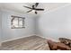 An inviting bedroom has wood floors, a window, and a ceiling fan at 8345 E Oak St, Scottsdale, AZ 85257