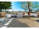 Charming single-story home featuring gravel landscaping, concrete pavers, and a fresh grey and white paint scheme at 8345 E Oak St, Scottsdale, AZ 85257
