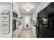 Galley-style kitchen featuring updated appliances, light blue cabinets, and a charming farmhouse-style sign at 8345 E Oak St, Scottsdale, AZ 85257