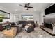 Bright living room with a corner fireplace, large gray sofa, and lots of natural light from the window at 8345 E Oak St, Scottsdale, AZ 85257