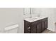 Neutral bathroom featuring a double sink vanity and a large mirror at 8530 W Trenton Ct, Florence, AZ 85132