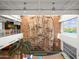 Indoor climbing wall next to a second story balcony and a full-height window, with an indoor palm tree at 8530 W Trenton Ct, Florence, AZ 85132
