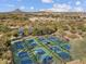 Aerial shot of multiple well-maintained pickleball courts surrounded by desert vegetation, perfect for outdoor recreation at 8530 W Trenton Ct, Florence, AZ 85132