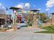 Inviting entrance to 'Adventure Playground' with colorful signage, framed by stone pillars and lush landscaping at 8530 W Trenton Ct, Florence, AZ 85132