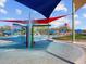 Close-up of the splash pad, featuring colorful structures, water features, and shaded areas for Gathering fun at 8530 W Trenton Ct, Florence, AZ 85132