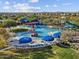 Aerial view of the vibrant water park with colorful slides, splash pads, and shaded seating areas for relaxation at 8530 W Trenton Ct, Florence, AZ 85132