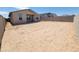Spacious backyard featuring a block wall and a covered patio, offering ample space for outdoor living and recreation at 8576 W Trenton Ct, Florence, AZ 85132