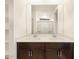 Bathroom with double sinks, a large mirror, and walk-in closet creates a spacious atmosphere at 8576 W Trenton Ct, Florence, AZ 85132