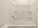 Clean bathroom featuring a tiled shower-tub combo with storage at 8576 W Trenton Ct, Florence, AZ 85132