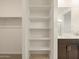 Shelves in the bathroom next to the sink and walk-in closet provide plenty of storage at 8576 W Trenton Ct, Florence, AZ 85132