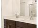 Bathroom features a large mirror above the double sinks and dark wood cabinets at 8576 W Trenton Ct, Florence, AZ 85132