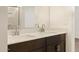 Modern bathroom features double sinks with a large mirror and dark wood cabinets at 8576 W Trenton Ct, Florence, AZ 85132