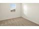 Cozy bedroom with plush carpeting, window with blinds, and a fresh coat of neutral paint at 8576 W Trenton Ct, Florence, AZ 85132