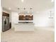 Modern kitchen with white island, pendant lighting, and stainless steel appliances at 8576 W Trenton Ct, Florence, AZ 85132