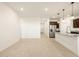 Bright kitchen open to living space, featuring stainless steel appliances and countertop seating at 8576 W Trenton Ct, Florence, AZ 85132