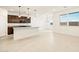 Open layout features a kitchen island, pendant lighting, and stainless steel appliances at 8576 W Trenton Ct, Florence, AZ 85132