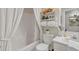Bright bathroom featuring a tub, shower, white vanity, and decorative shelving at 9231 E Carmel Ave, Mesa, AZ 85208