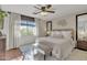 Serene bedroom with a ceiling fan, area rug, and natural light from the window at 9231 E Carmel Ave, Mesa, AZ 85208