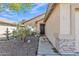 Charming home entryway featuring stone accents, desert landscaping, and a welcoming walkway leading to the front door at 9231 E Carmel Ave, Mesa, AZ 85208
