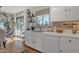 Well-lit kitchen area featuring white cabinets and views of the backyard at 9231 E Carmel Ave, Mesa, AZ 85208