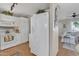 Bright kitchen with white appliances and cabinets near a sunny living area at 9231 E Carmel Ave, Mesa, AZ 85208