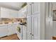 An efficient kitchen offers white cabinetry, appliances, and ample storage space at 9231 E Carmel Ave, Mesa, AZ 85208